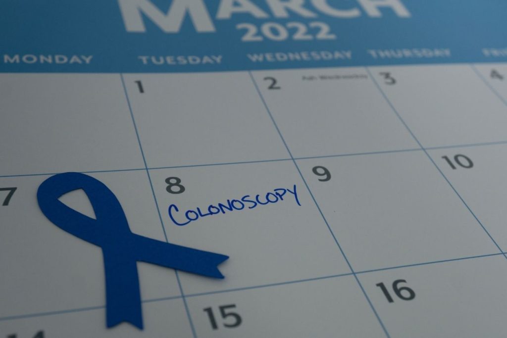 Blue ribbon on calendar to remember colonoscopy appointment