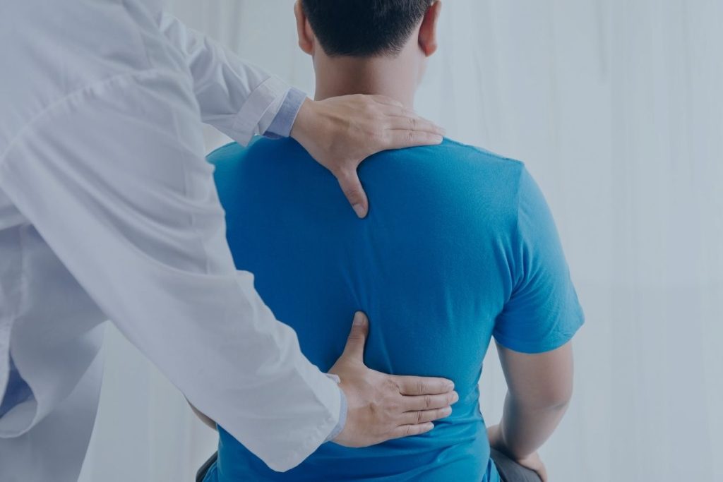 Doctor examining person illustrating Osteopathic Manual Therapy