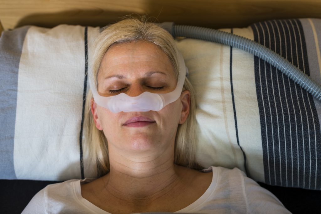 Woman sleeping with cpap mask