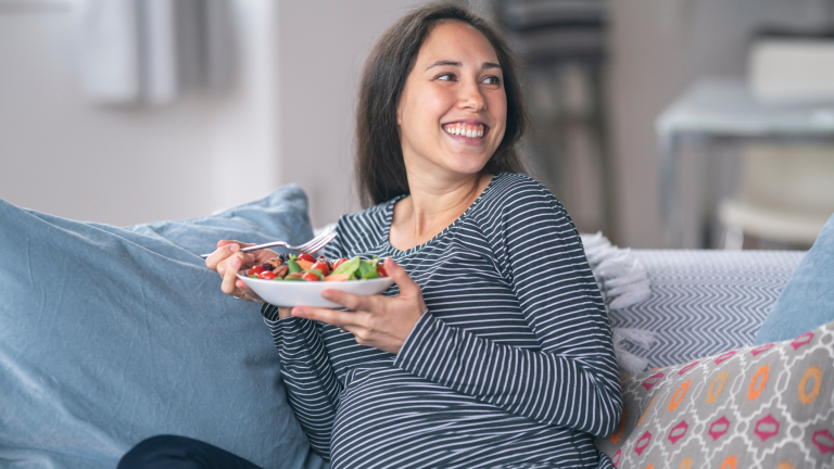 pregnant woman eating healthy salad