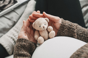 women’s health pregnancy holding a bear