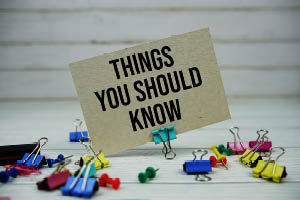 Person journaling health goals for the new year with tea and planner