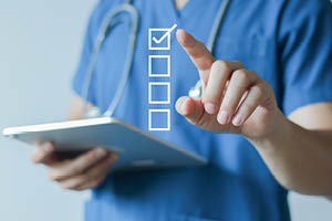 Doctor discussing health screening schedule by age group with patient